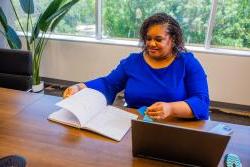 Andrea Durham behind a desk